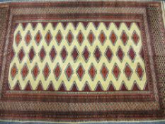 EASTERN STYLE WOOLLEN CARPET, red and cream ground with multi-diamond block central panel and