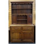 SMALL ANTIQUE OAK DRESSER, boarded rack with small cupboards, on a base fitted with two frieze