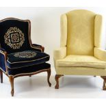 TWO WINGBACK ARMCHAIRS, comprising a George II style armchair upholstered in yellow floral damask