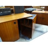 MID-CENTURY TEAK METAMORPHIC DESK with swing out side and ebonised top, together with small mid-