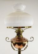 ARTS & CRAFTS BRASS AND COPPER STANDARD OIL LAMP, with foliate decorated tripod base and column,