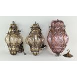 THREE VENETIAN GLASS & METAL FRAMED HALL LANTERNS, comprising a pair in smoky glass, 30cms high, and