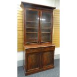 19TH CENTURY MAHOGANY BOOKCASE, angled cornice above glazed doors with gilt brass moulding and