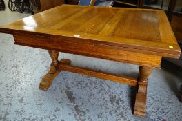 REPRODUCTION JACOBEAN STYLE OAK DRAW LEAF DINING TABLE, carved column supports on sleigh feet joined