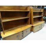 PAIR OF UNUSUAL TEAK LAMINATE HANGING SHELF UNITS with bowed cupboard and drawer bases, 121 x 39 x