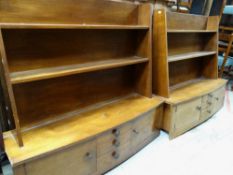 PAIR OF UNUSUAL TEAK LAMINATE HANGING SHELF UNITS with bowed cupboard and drawer bases, 121 x 39 x