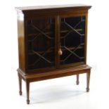 GEORGE III-STYLE MAHOGANY & BOXWOOD STRUNG BOOKCASE ON STAND, inlaid frieze above astragal glazed