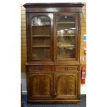 VICTORIAN WALNUT BOOKCASE, ogee cornice above glazed arched doors on a cupboard base fitted two