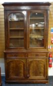 VICTORIAN WALNUT BOOKCASE, ogee cornice above glazed arched doors on a cupboard base fitted two