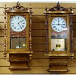 TWO AMERICAN WALNUT MARQUETRY DROP DIAL WALL CLOCKS, with 8 inch roman white enamel dials, turned