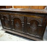 17TH CENTURY-STYLE OAK COFFER, panelled moulded top above arch carved triple panelled front, moulded
