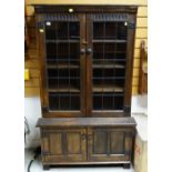 NIGEL GRIFFITHS STAINED OAK BOOKCASE, with leaded and glazed doors on cupboard base, 92 x 152cms
