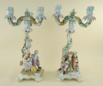 PAIR MEISSEN PORCELAIN FIGURAL CANDELABRA, 19th Century, the rococo scrolled columns mounted with