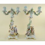 PAIR MEISSEN PORCELAIN FIGURAL CANDELABRA, 19th Century, the rococo scrolled columns mounted with