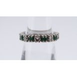 18CT WHITE GOLD, EMERALD & DIAMOND HALF ETERNITY RING comprising eight emeralds and seven