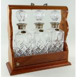 MODERN TRIPLE DECANTER TANTALUS, fitted with silver mounted whiskey decanters, Birmingham 1985,