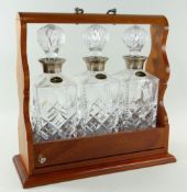 MODERN TRIPLE DECANTER TANTALUS, fitted with silver mounted whiskey decanters, Birmingham 1985,