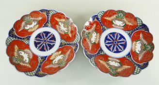 PAIR OF JAPANESE GOSEI IMARI KIKUGATA DISHES, with panels of stylised animal and plant motifs, 34cms