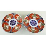 PAIR OF JAPANESE GOSEI IMARI KIKUGATA DISHES, with panels of stylised animal and plant motifs, 34cms