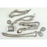 THREE SILVER CURB LINK ALBERT CHAINS, with swivel hooks, fobs, a vesta case and a 1887 shilling,