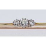 THREE-STONE DIAMOND BAR BROOCH in yellow metal setting, diamond weight 0.2ct overall (visual