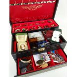 ASSORTED COSTUME JEWELLERY comprising brooches, earrings ETC in a folding black leather jewellery