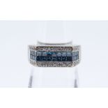 18K WHITE GOLD FOUR ROW RING, comprising 26 square cut blue diamonds and 26 small brilliant cut d