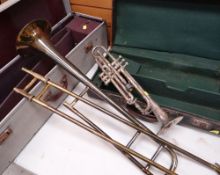 TWO BRASS MUSICAL INSTRUMENTS comprising Boosey & Hawkes Ltd trombone and Higham Magna silvered