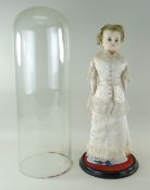 19TH CENTURY WAX SHOULDER HEAD DOLL, with satin dress with lace trim, with glass dome, 40cms high