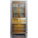 VINTAGE OAK BUREAU BOOKCASE, the upper section with leaded glass doors and adjustable interior