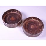 SILVER WITH MAHOGANY BOTTOM WINE BOTTLE COASTERS, A PAIR, London 1978, maker W K B, 12cms diameter