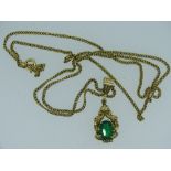 9CT GOLD EMERALD SET PENDANT DROP & NECKLACE, the oval cut stone in a raised setting and ornate