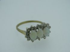 9CT GOLD OPAL & POSSIBLY WHITE SAPPHIRE DRESS RING, matched triple opals, claw set to a surround