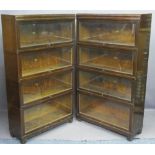 OAK GLOBE-WERNICKE BOOKCASES, a pair, graduated four section with lift-up glazed doors, 146cms H,