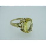 LARGE CITRINE MOUNTED 9CT GOLD DRESS RING, the oval stone in a raised 'Arts and Craft' style