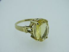 LARGE CITRINE MOUNTED 9CT GOLD DRESS RING, the oval stone in a raised 'Arts and Craft' style