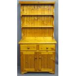 PINE DRESSER of compact design, two shelves over base with two drawer and two cupboard doors, 180cms