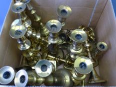 BRASS CANDLE HOLDERS from miniature to full size, a very large parcel and a brass chamber stick