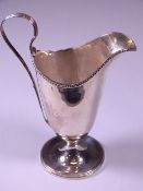 GEORGE IV HELMET SHAPED CREAM JUG, London 1820, plain form with bead edge detail on a circular base,