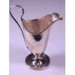 GEORGE IV HELMET SHAPED CREAM JUG, London 1820, plain form with bead edge detail on a circular base,