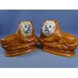 STAFFORDSHIRE RECUMBENT LIONS, A PAIR, 28cms and 29cms