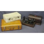 A CASED 'NEW HOME' SEWING MACHINE COMPANION and two vintage suitcases