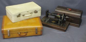 A CASED 'NEW HOME' SEWING MACHINE COMPANION and two vintage suitcases