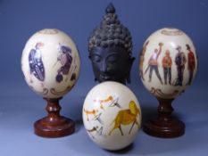 OSTRICH EGGS (3) transfer decorated with military and Zulu scenes and a cast bronze Eastern bust