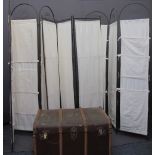 WOODEN BANDED TRAVEL TRUNK and three tri-fold metal and canvas screens, 188cms H, 126cms W the