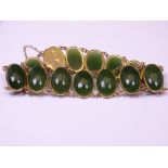A 9CT GOLD BRACELET with 15 oval cabochon Jadeite style, 18.5grms gross