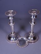CIRCULAR BASED CANDLESTICKS, A PAIR and a small hallmarked silver pindish, 23cms H the candlesticks,
