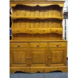 PINE DRESSER with shaped frieze over two shelves, the lower with four small drawers, the base