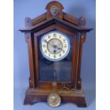 MANTEL CLOCK with steeple top and lion motif, 42cms H