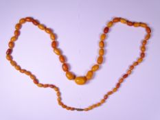 VINTAGE AMBER OVAL BEAD NECKLACE, 66.5grms gross, 104cms L of 67 individually knotted graduated